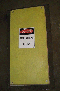 Penetration cover showing sign and fixings at each corner