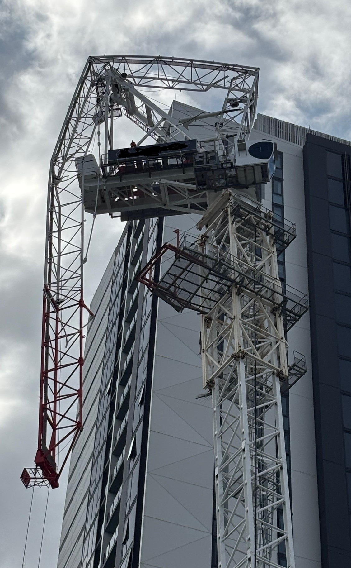 Luffing tower crane being blown backwards on a construction site on the Gold Coast