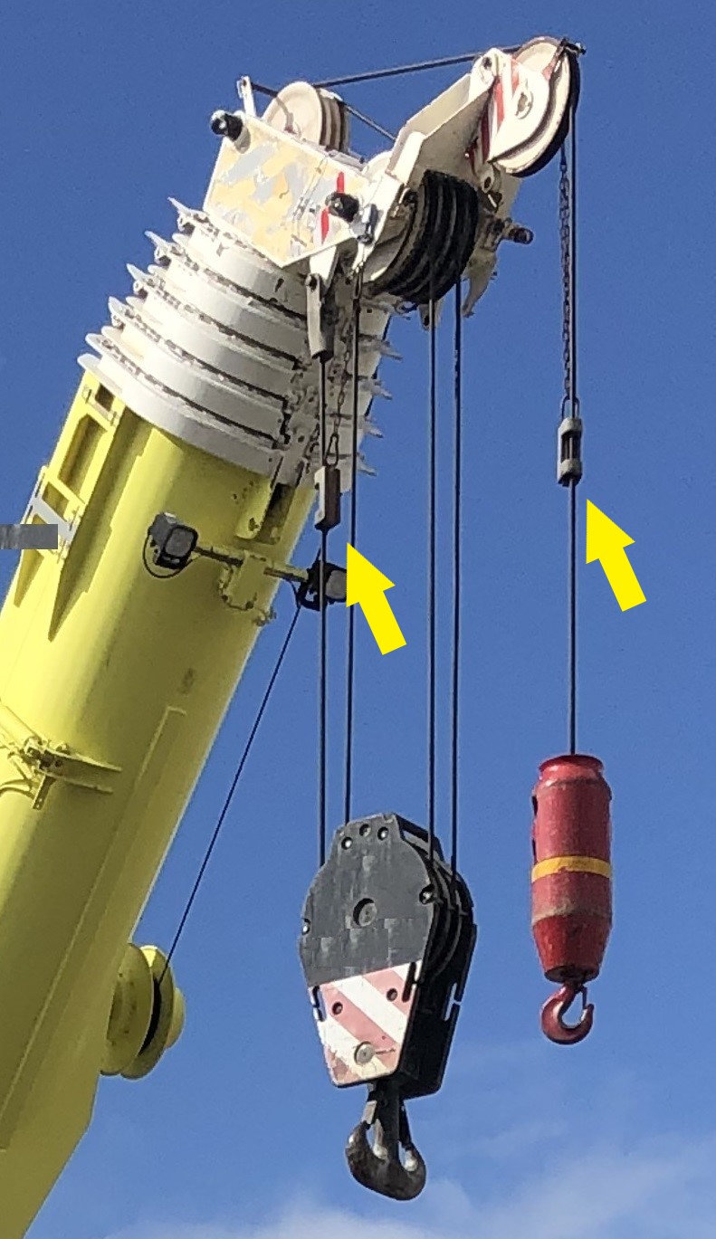 Anti-two block weights on a mobile crane (indicated by arrows).